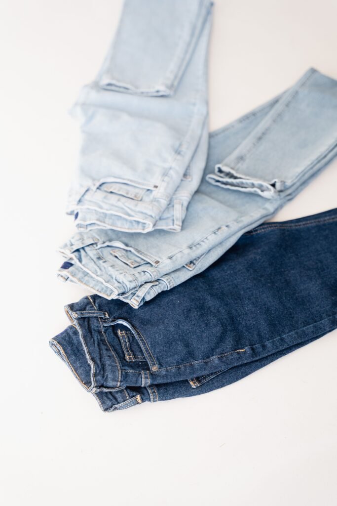 Light and dark wash women's jeans folded on a white background